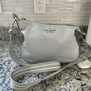 Dove grey kate spade purse. Comes with two straps. Great condition